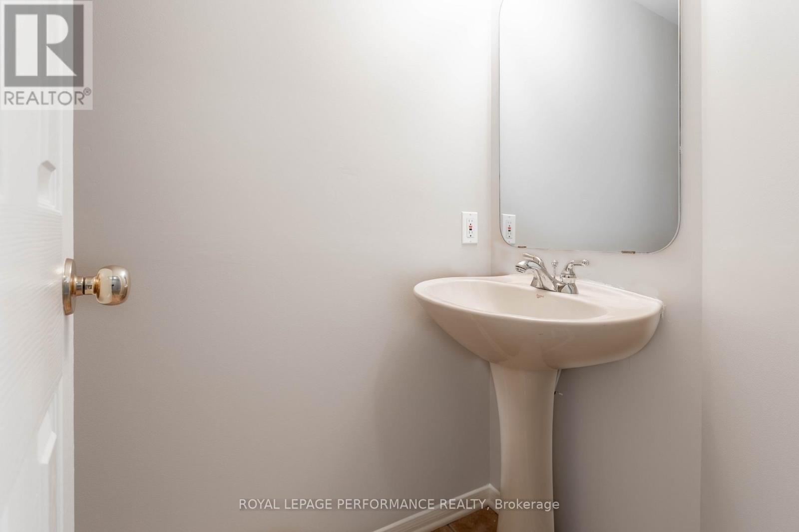 A white bathroom sink with a mirror above it.