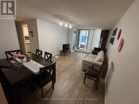 A living room with a dining table and chairs.