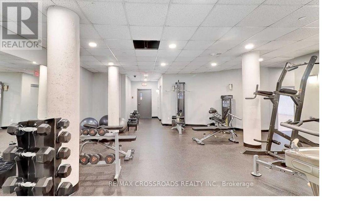 A gym with a variety of equipment including dumbbells, weight machines, and a bench press.