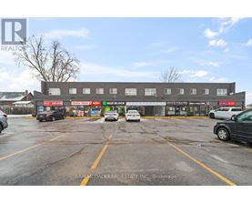 A parking lot with cars and a building in the background.