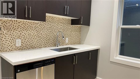A kitchen with brown cabinets and a white counter top.