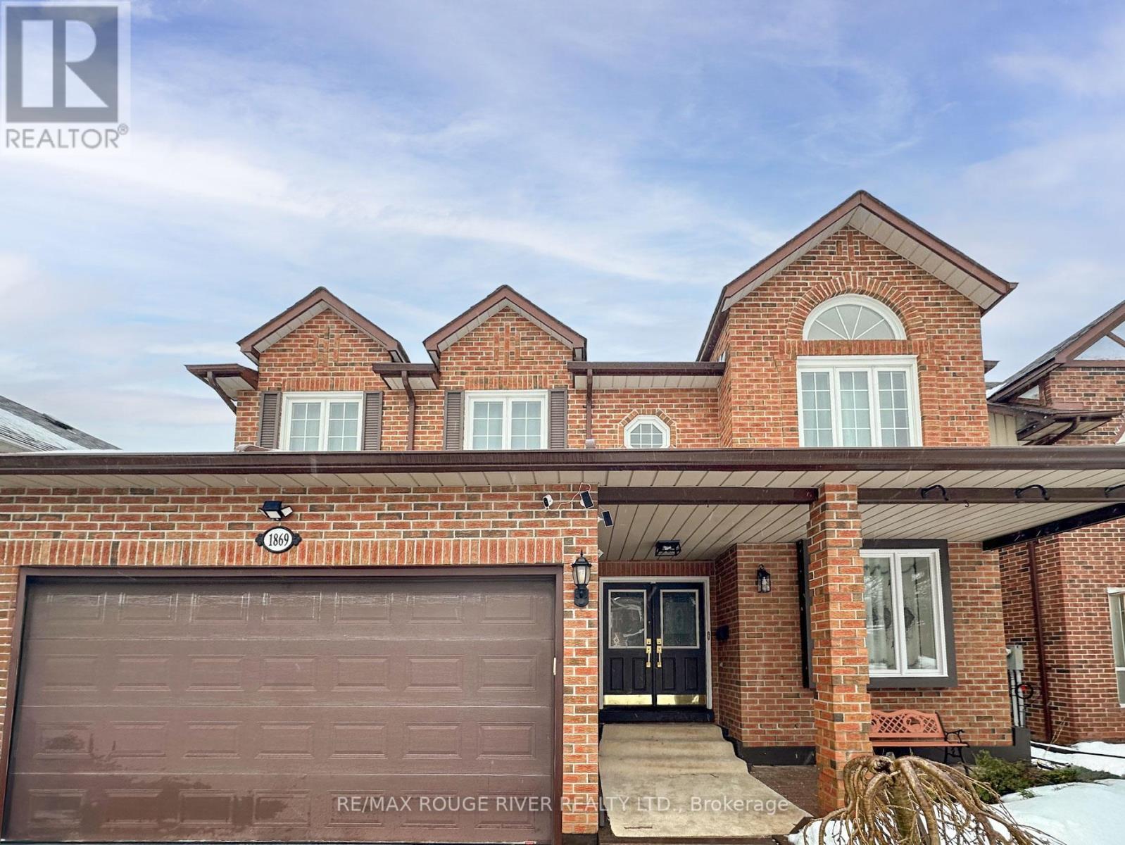 A house with a brown garage door is for sale.