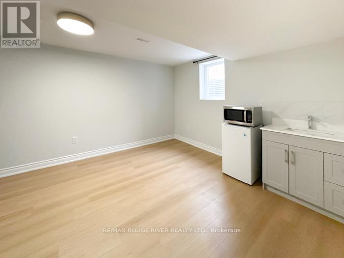 A kitchen area with a microwave on the counter.