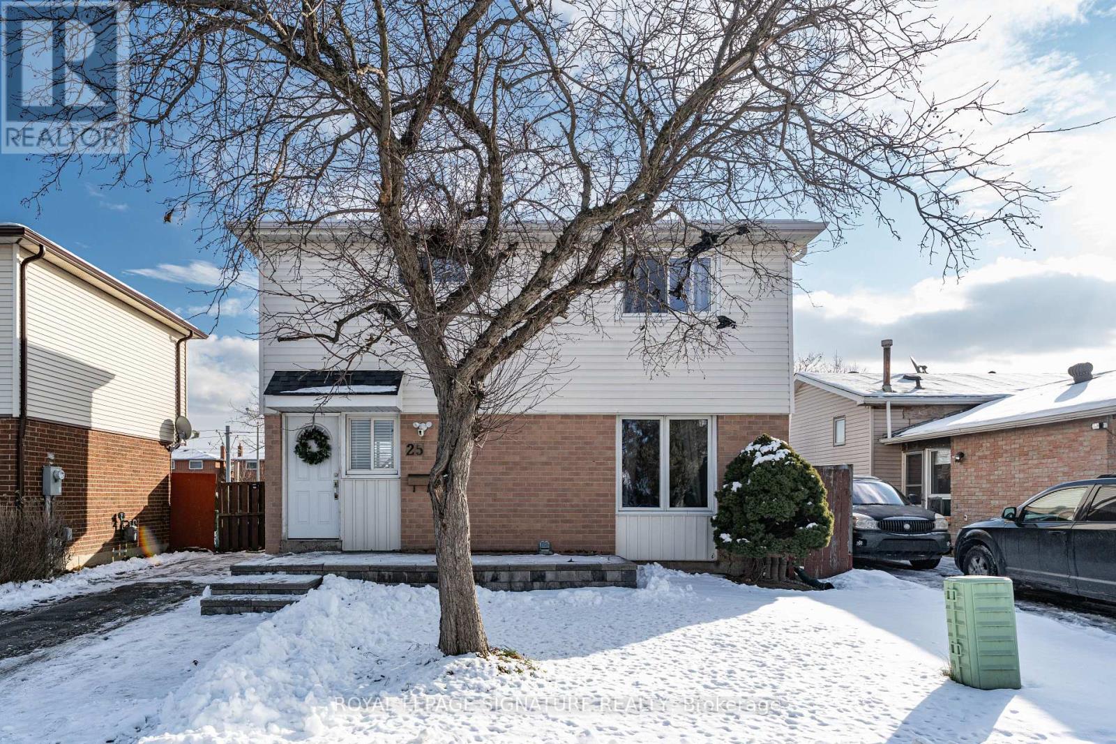 A house with a white door and a tree in front of it.