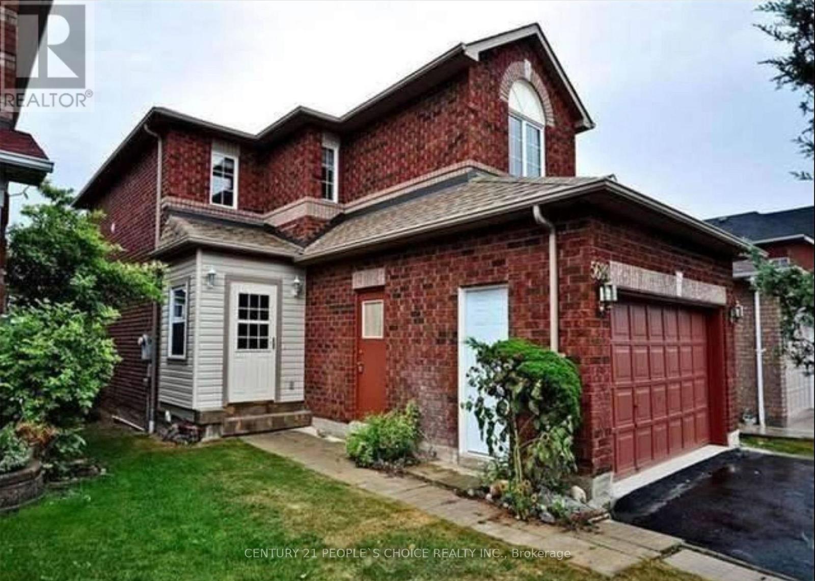 A red brick house with a white door and a garage door.