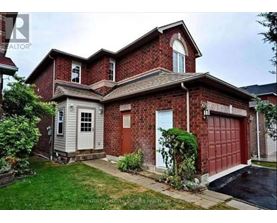 A red brick house with a white door and a garage door.