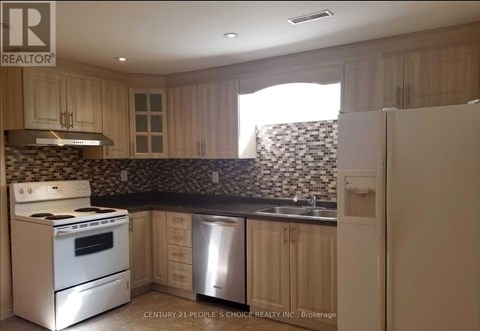 A kitchen with a stove top oven and a dishwasher.