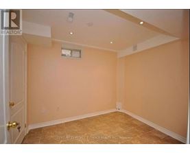 A room with beige walls and a window with a white frame.