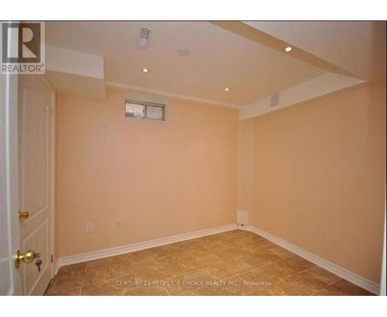 A room with beige walls and a window with a white frame.