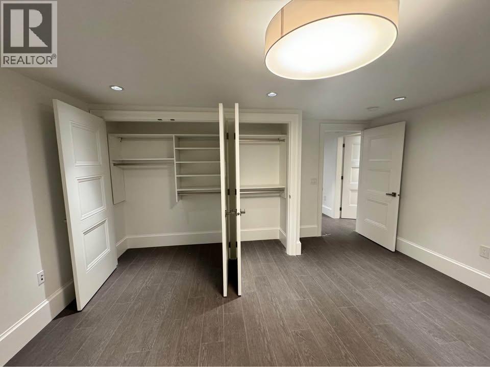 A bedroom with a built-in bed and a grey carpet.