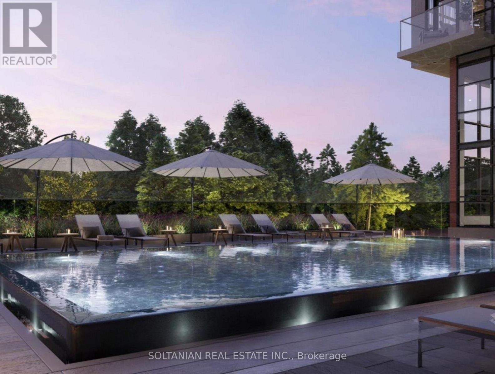 A pool area with lounge chairs and umbrellas is shown.