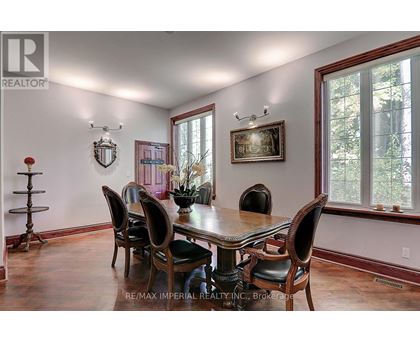 A dining room with a table set for six.