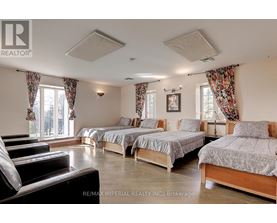 A bedroom with two beds and a couch.