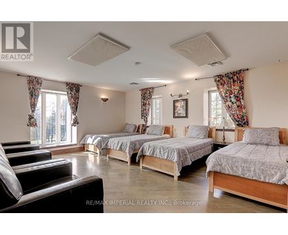 A bedroom with two beds and a couch.