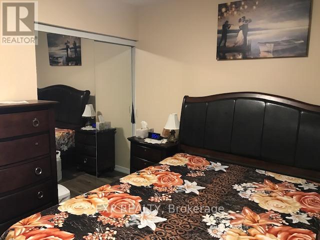 A bedroom with a large bed and a dresser.