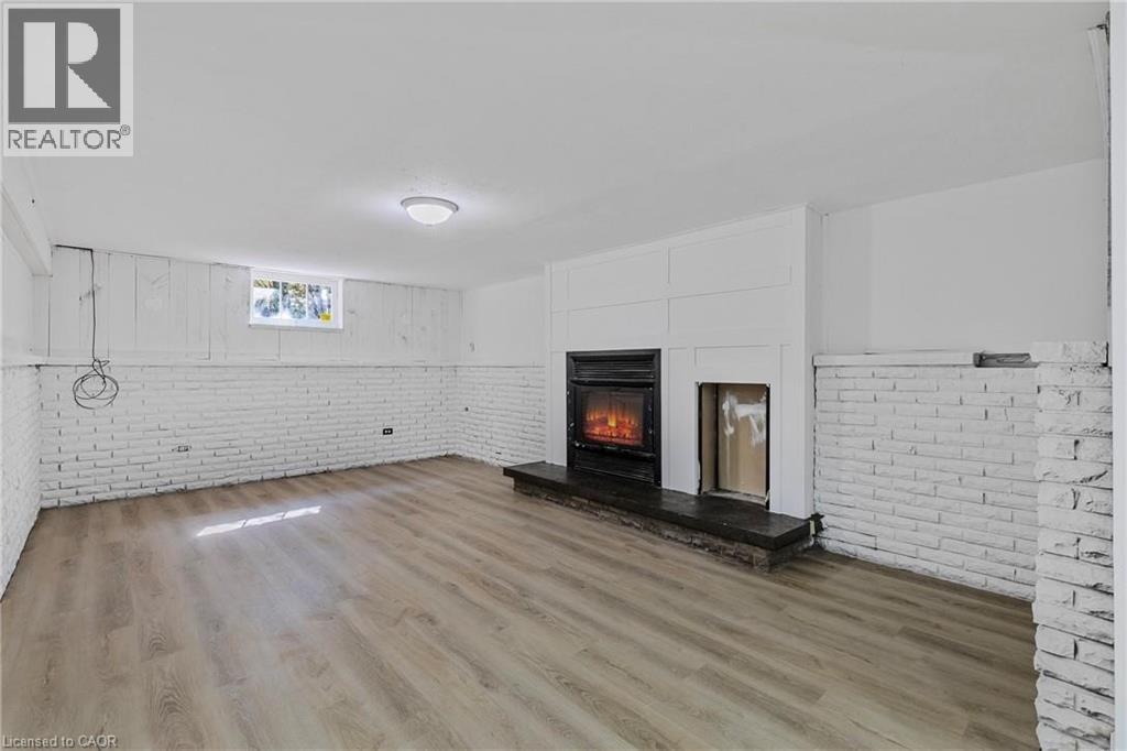 A modern living room with a fireplace and wooden flooring.