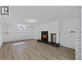 A modern living room with a fireplace and wooden flooring.