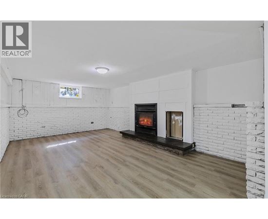 A modern living room with a fireplace and wooden flooring.