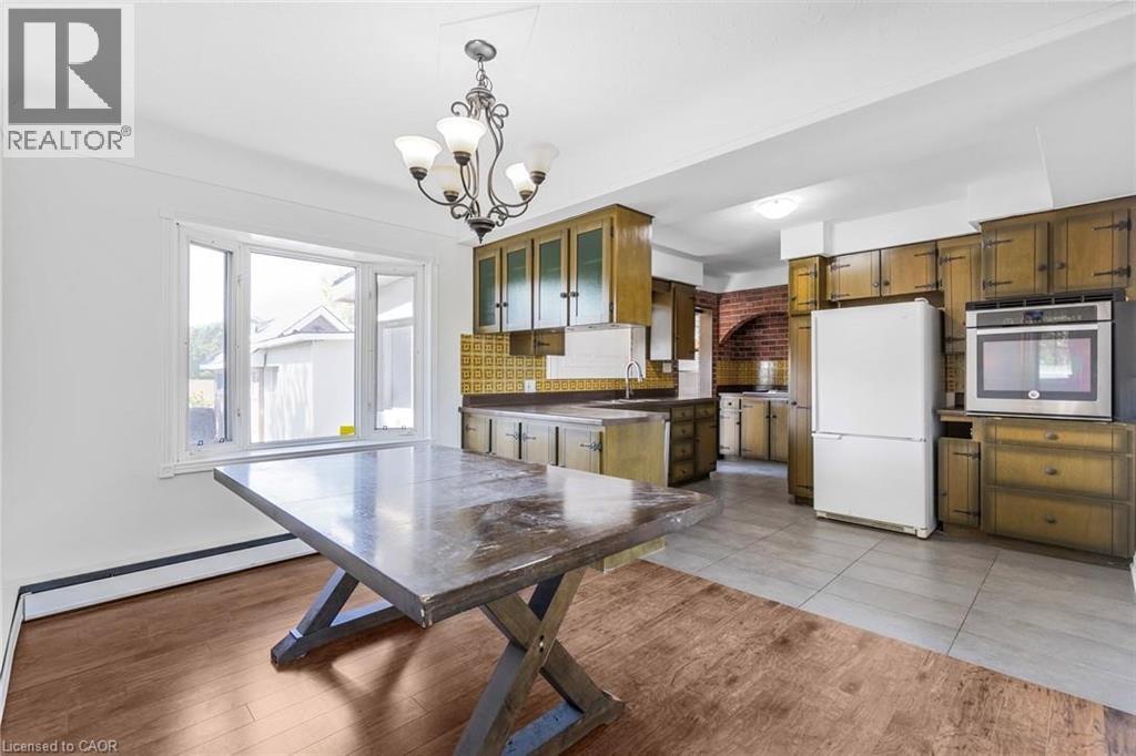 A kitchen with a table and a refrigerator.