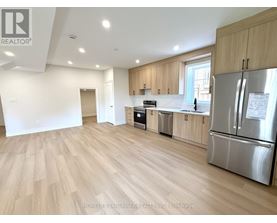 A kitchen with wooden floors and stainless steel appliances.
