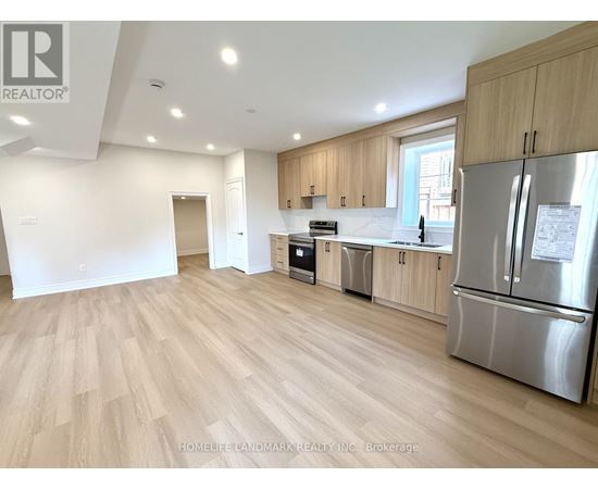 A kitchen with wooden floors and stainless steel appliances.