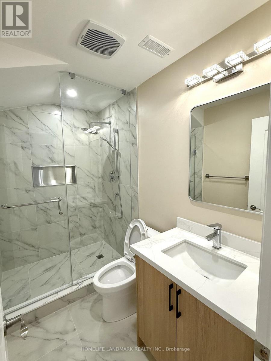 A white sink in a marble bathroom.