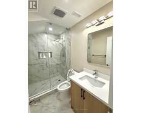 A white sink in a marble bathroom.