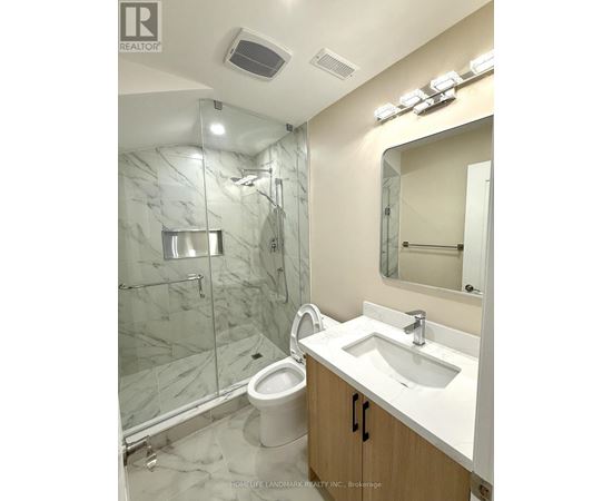 A white sink in a marble bathroom.