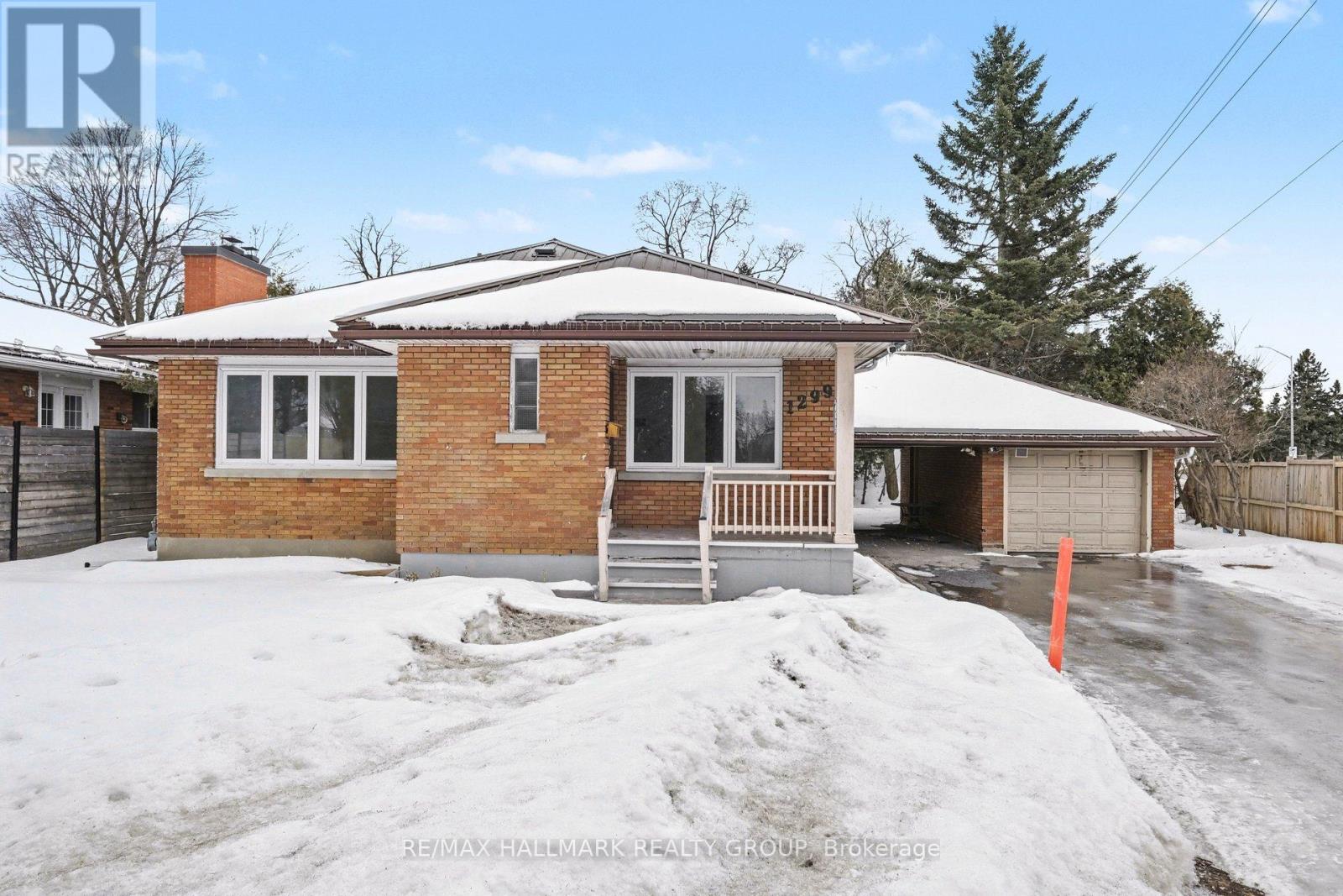 A house with a snow-covered front yard.