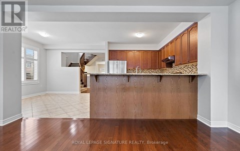 A spacious kitchen with wooden cabinets and a countertop.