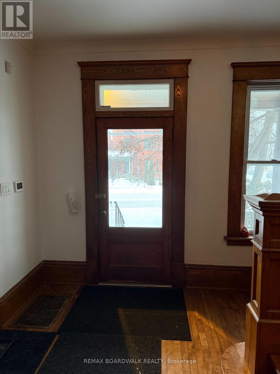 A brown door with a window above it.