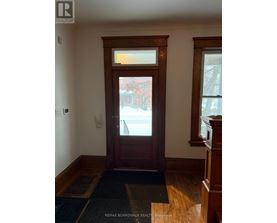 A brown door with a window above it.