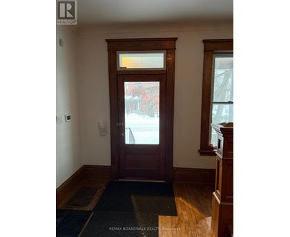 A brown door with a window above it.