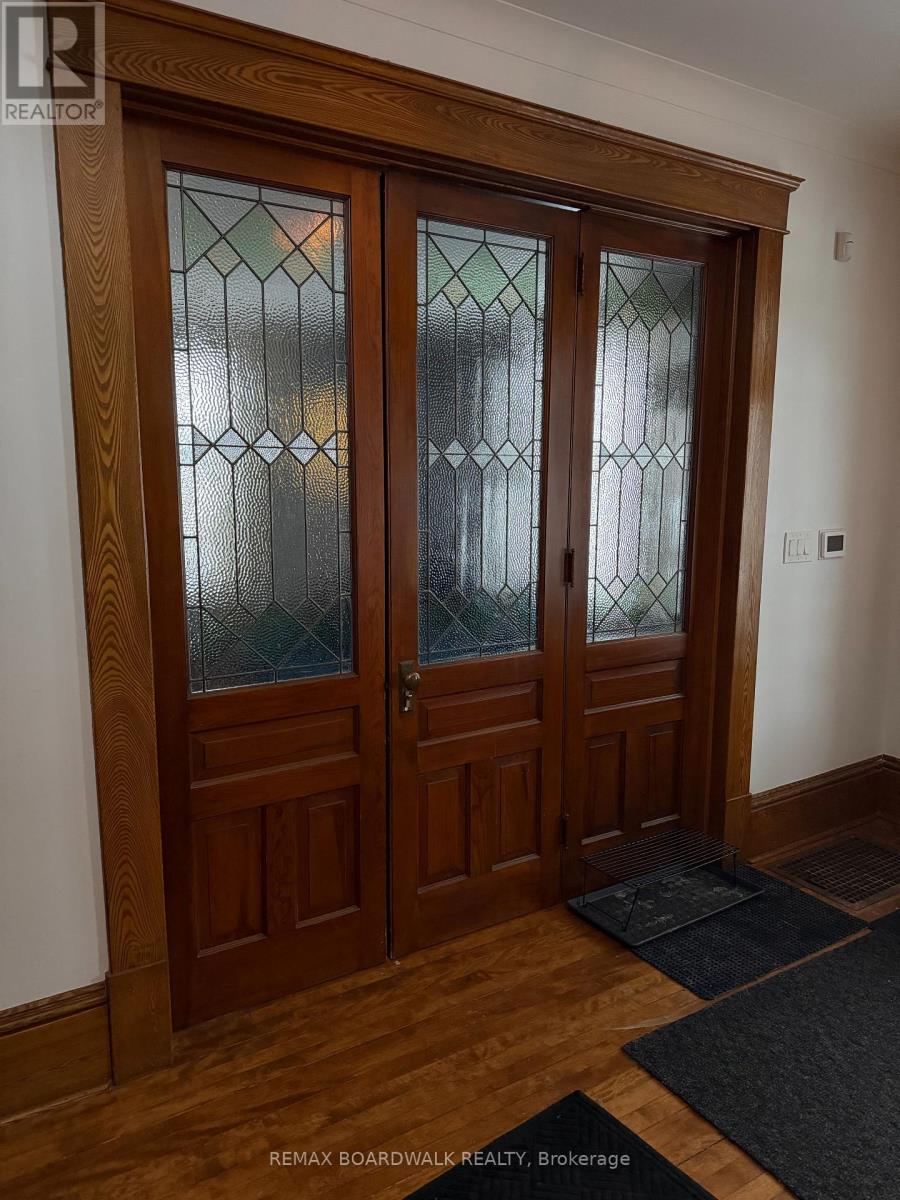 A pair of wooden doors with glass panels in the middle.