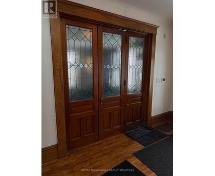 A pair of wooden doors with glass panels in the middle.