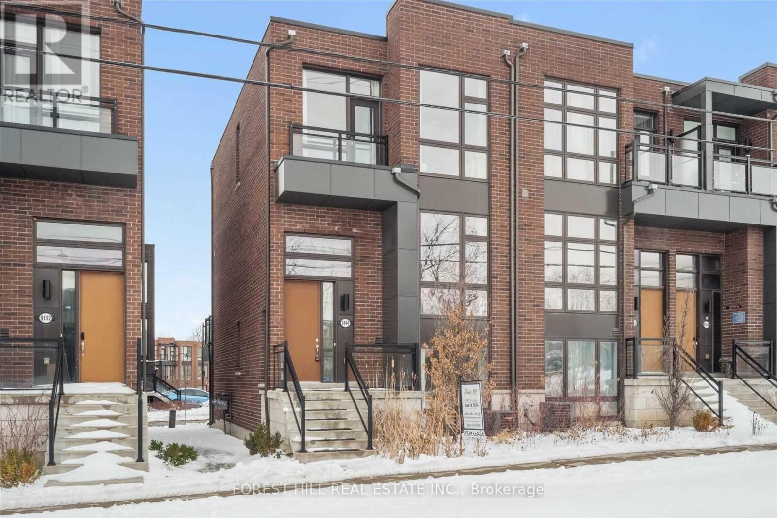 A row of townhouses with brick exteriors and balconies.