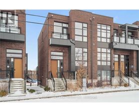 A row of townhouses with brick exteriors and balconies.