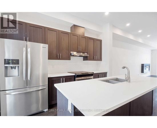 A modern kitchen with a stainless steel refrigerator and wooden cabinets.