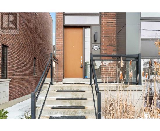 A brown door is on the right side of a brick building.