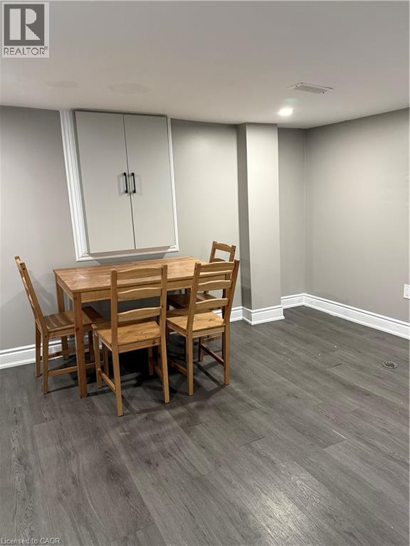 A dining room with a wooden table and chairs.