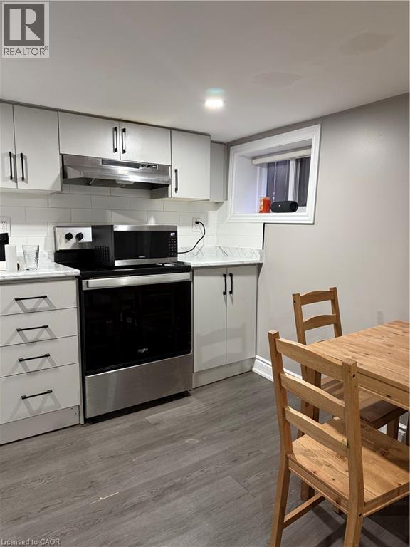 A kitchen with a wooden table and chairs.