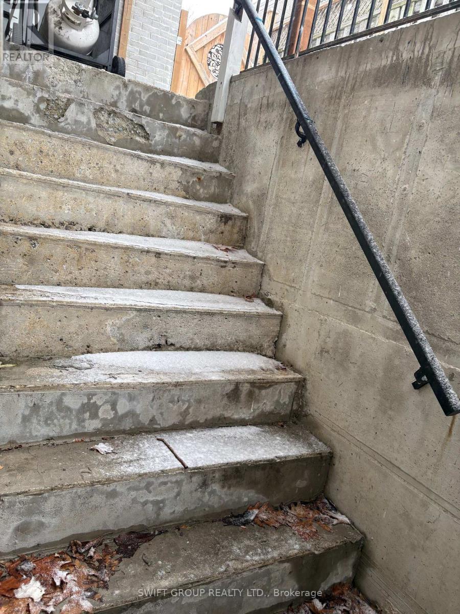 A concrete staircase with a metal handrail.
