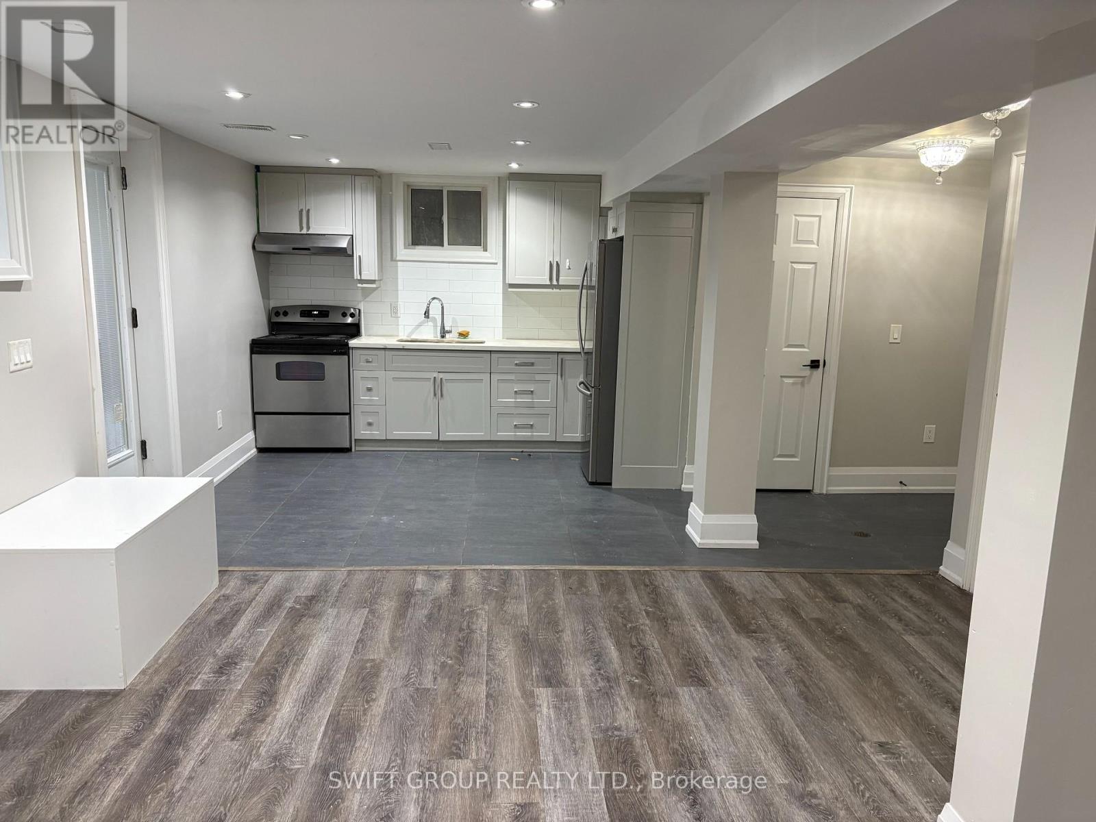 A kitchen with a stove top oven, microwave, and refrigerator.