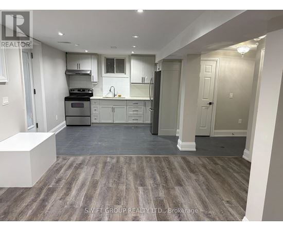 A kitchen with a stove top oven, microwave, and refrigerator.