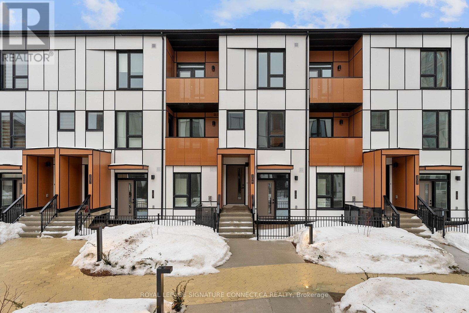 A modern apartment building with a mix of white and brown balconies.