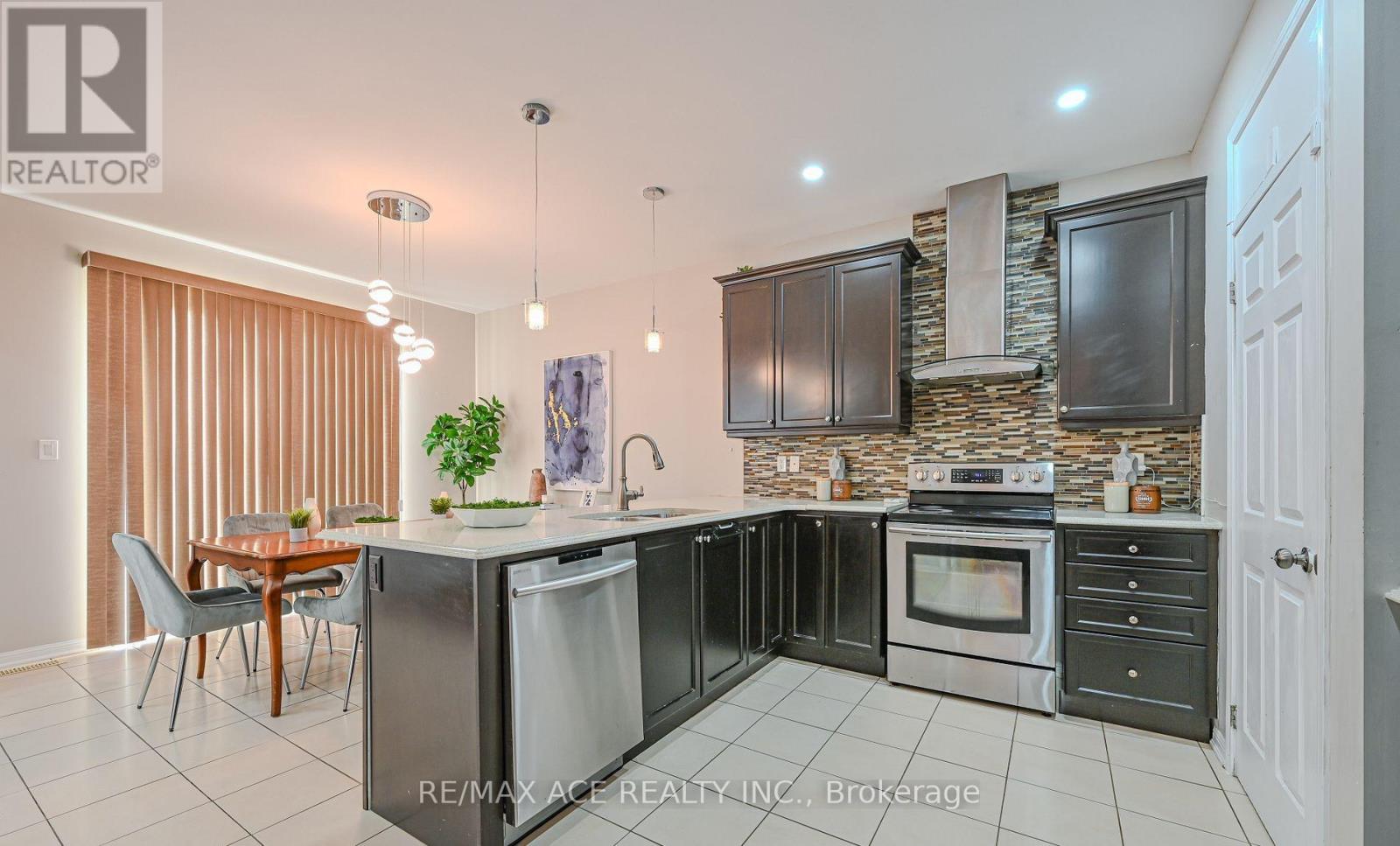 A modern kitchen with a large island and stainless steel appliances.
