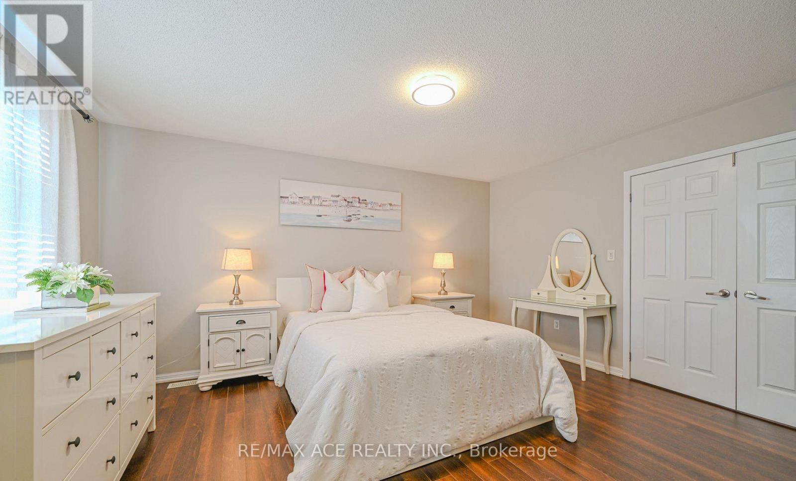A bedroom with a bed, dresser, and nightstand.