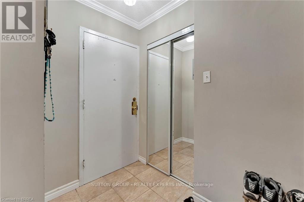 A hallway with a white door and a mirrored door.