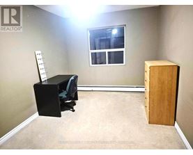 A hallway with a white door and a mirrored door.