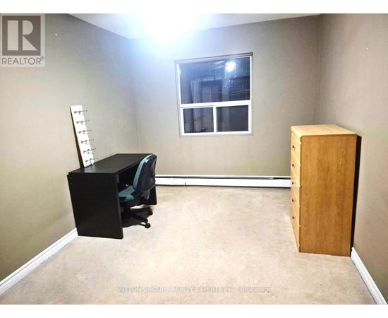 A hallway with a white door and a mirrored door.